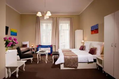 a bedroom with a bed and a living room at Leone Aparthotel in Kraków