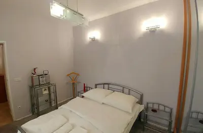 a bedroom with a bed with two white pillows at Apartament Oficyna in Kraków