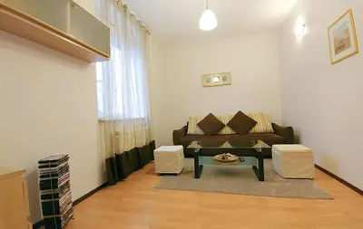 a living room with a couch and a table at Apartament Oficyna in Kraków