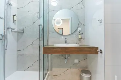 a bathroom with a sink and a mirror at RAJSKA 3 by PI Apartments in Kraków