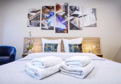 a bedroom with a bed with towels on it at RAJSKA 3 by PI Apartments in Kraków