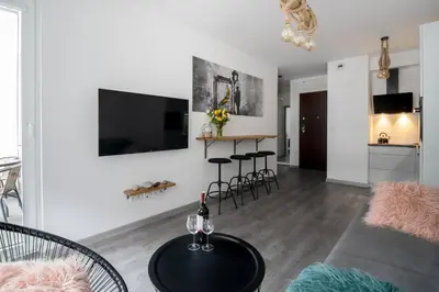 a living room with a couch and a table at Unique apt EVE - free garage in Kraków