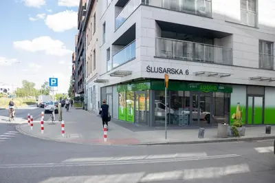 a woman walking down a street in front of a building at Unique apt EVE - free garage in Kraków