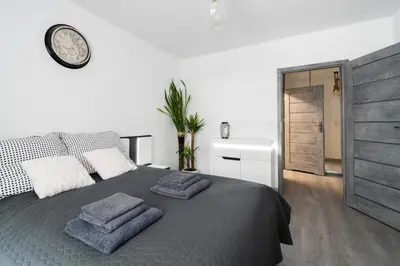 a bedroom with a bed with two towels on it at Unique apt EVE - free garage in Kraków