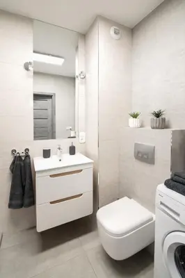 a white bathroom with a toilet and a sink at Unique apt EVE - free garage in Kraków