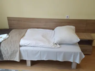 a bed with white sheets and pillows on it at CKS Kraków (Centrum Konferencyjno-Szkoleniowe CS Natura Tour) in Kraków