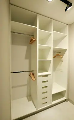 a walk in closet with white cabinetry at Jewish Quarter Comfort - In City Apartments in Kraków