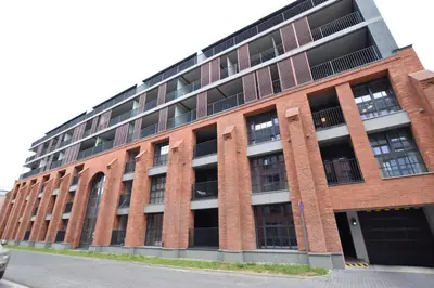 a large red brick building with a lot of windows at Jewish Quarter Comfort - In City Apartments in Kraków