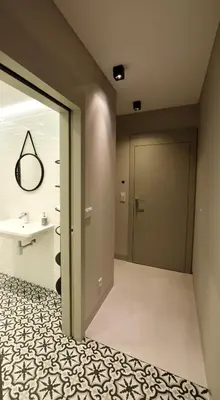a bathroom with a door and a tile floor at Jewish Quarter Comfort - In City Apartments in Kraków