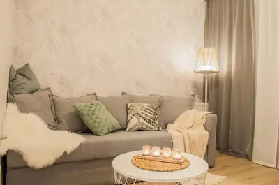 a living room with a gray couch and a table at Brown Sugar | free garage | 2 separate rooms in Kraków