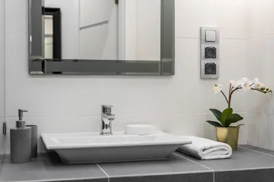 a bathroom with a sink and a mirror at Rajska 3 by Atrium Apartments in Kraków