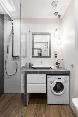 a bathroom with a washing machine and a sink at Rajska 3 by Atrium Apartments in Kraków