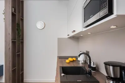 a kitchen with a sink and a microwave at Rajska 3 by Atrium Apartments in Kraków
