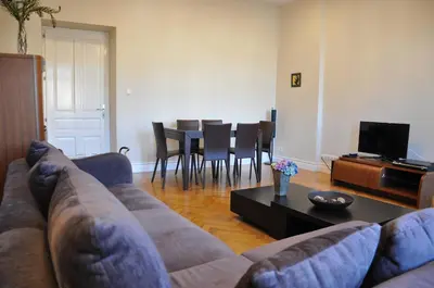a living room with a couch and a table at Tresor Barska Apartments in Kraków