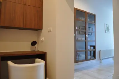 a kitchen with a table and a chair in a room at Tresor Barska Apartments in Kraków