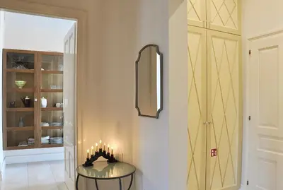 a hallway with a glass table and a mirror at Tresor Barska Apartments in Kraków