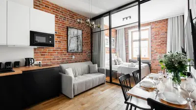 a living room with a couch and a table at Aparthotel Delta Boutique in Kraków