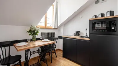 a small kitchen with a table and a microwave at Aparthotel Delta Boutique in Kraków