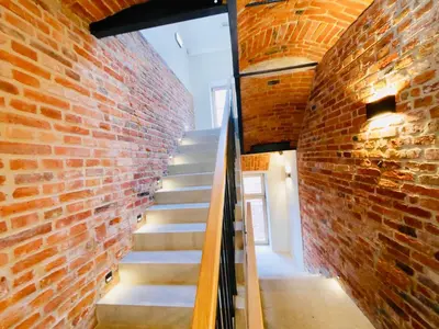 a staircase in a brick wall with a stair case at Aparthotel Delta Boutique in Kraków