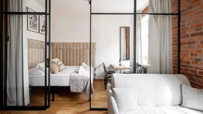 a living room with a bed and a couch at Aparthotel Delta Boutique in Kraków