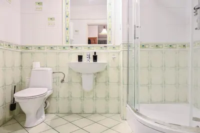 a bathroom with a toilet and a sink and a shower at D&A Apartments Szewska in Kraków