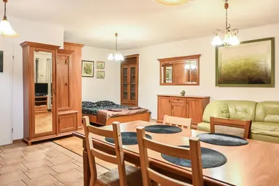 a living room with a table and a couch at D&A Apartments Szewska in Kraków