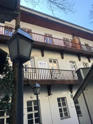 a street light in front of a building with balconies at D&A Apartments Szewska in Kraków