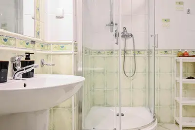a bathroom with a sink and a shower at D&A Apartments Szewska in Kraków