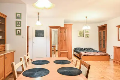 a room with a table and chairs and a bed at D&A Apartments Szewska in Kraków