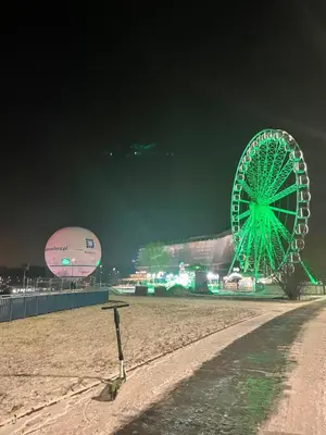 a large green ferris wheel on the beach at night at XXL Apartment Old Town 24 h - check in, Wi-Fi in Kraków