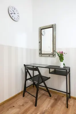 a black desk with a mirror and a chair at XXL Apartment Old Town 24 h - check in, Wi-Fi in Kraków
