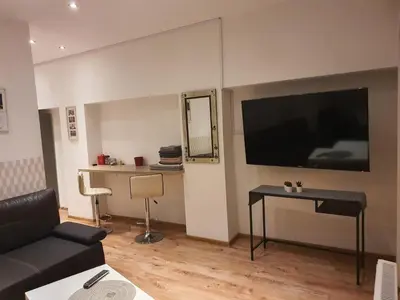a living room with a large flat screen tv on the wall at XXL Apartment Old Town 24 h - check in, Wi-Fi in Kraków
