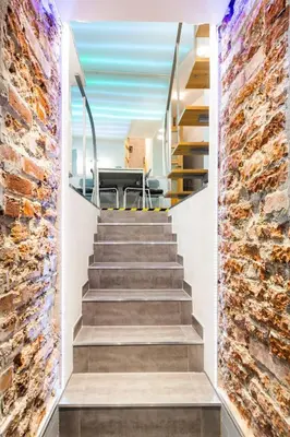 a staircase in a house with a brick wall at XXL Apartment Old Town 24 h - check in, Wi-Fi in Kraków