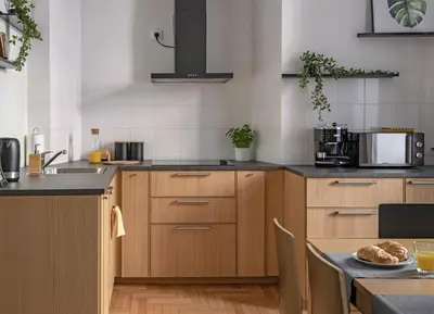 a kitchen with wooden cabinets and a table with a plate of food at 3D FLORIANSKA 15 Apartament in Kraków
