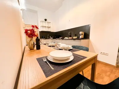 a dining room with a table with plates on it at 3D FLORIANSKA 15 Apartament in Kraków