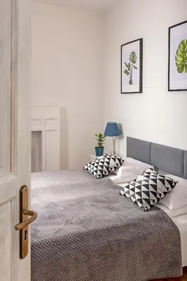 a bedroom with two beds with pillows on them at 3D FLORIANSKA 15 Apartament in Kraków