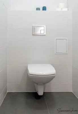 a bathroom with a white toilet in a room at 3D FLORIANSKA 15 Apartament in Kraków