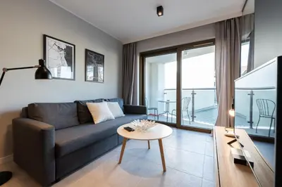 a living room with a couch and a table at City Lights Rakowicka 15 in Kraków