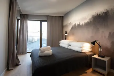 a bedroom with a bed with white pillows on it at City Lights Rakowicka 15 in Kraków