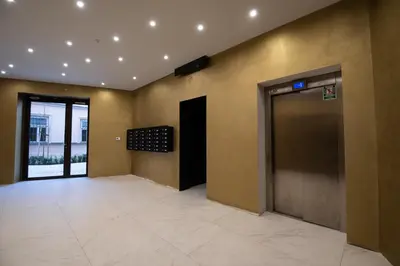 an empty lobby with an elevator and a door at City Lights Rakowicka 15 in Kraków