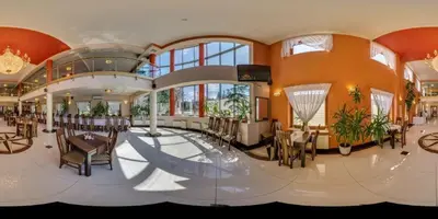 a large room with tables and chairs in a building at Vinci Hotel Airport in Modlniczka