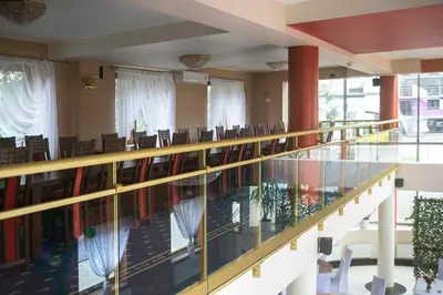 a large room with chairs and a glass floor at Vinci Hotel Airport in Modlniczka