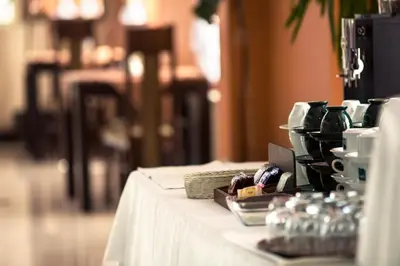 a table with a white table cloth on it at Vinci Hotel Airport in Modlniczka