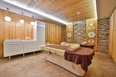 a bedroom with two beds and a sink at Hotel&SPA Jawor in Zawoja