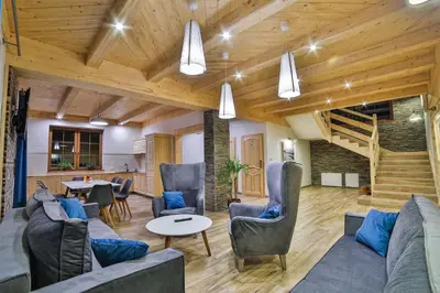 a living room with a couch and chairs and a table at Hotel&SPA Jawor in Zawoja
