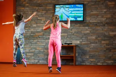 two girls playing a video game on the wii at Hotel&SPA Jawor in Zawoja