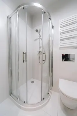 a glass shower in a bathroom with a toilet at M1 Main Square Studio in Kraków