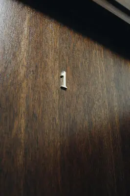 a wooden door with a small hole in it at M1 Main Square Studio in Kraków