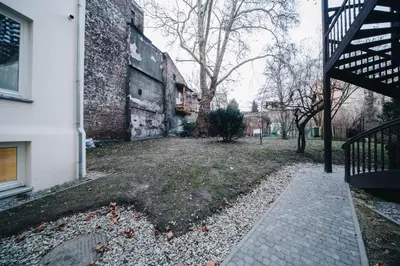 an empty yard next to a building with a staircase at M1 Main Square Studio in Kraków