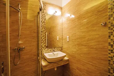 a bathroom with a sink and a shower at Hotel Tatarscy - ENERGYLANDIA in Kalwaria Zebrzydowska